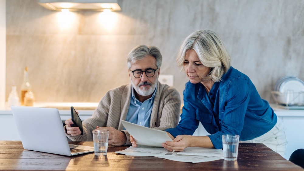 couple facing collection and examining financial hardship