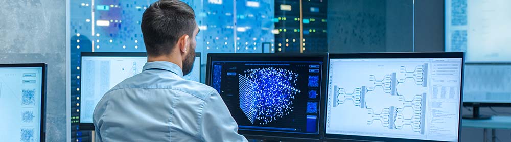 consultant-working-on-several-computer-screens-mobile Consultant working on several computer screens