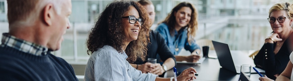 Consultants discussing business around a conference table