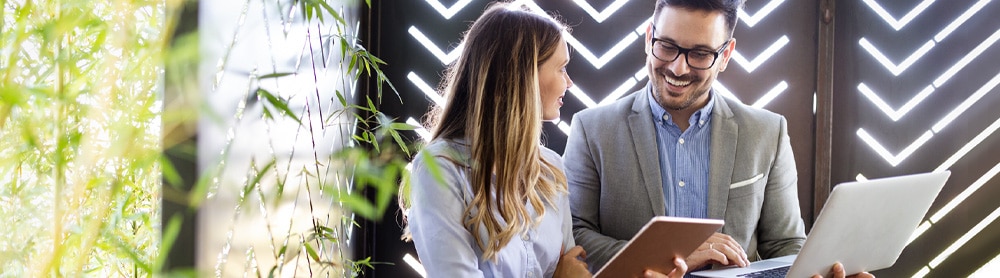consultants-discussing-business-on-laptop Consultants discussing business on laptop