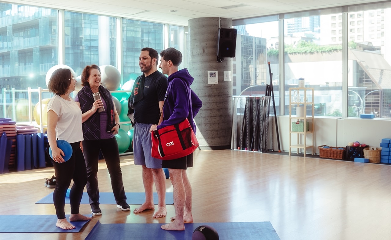 Group of people talking in a fitness room Group of people talking in a fitness room