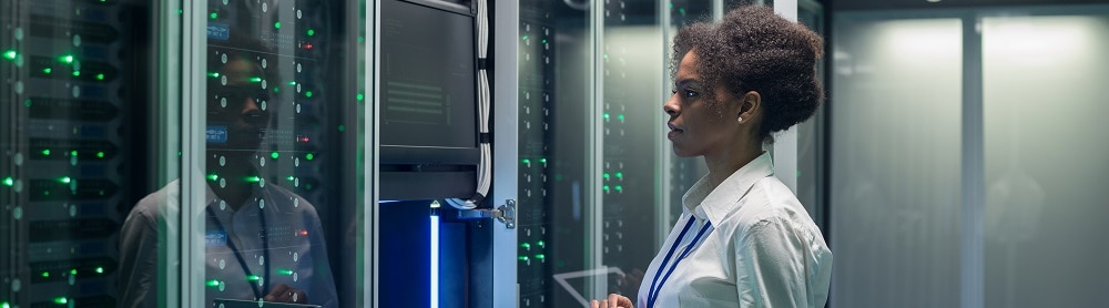 engineer standing in front of computers engineer standing in front of computers