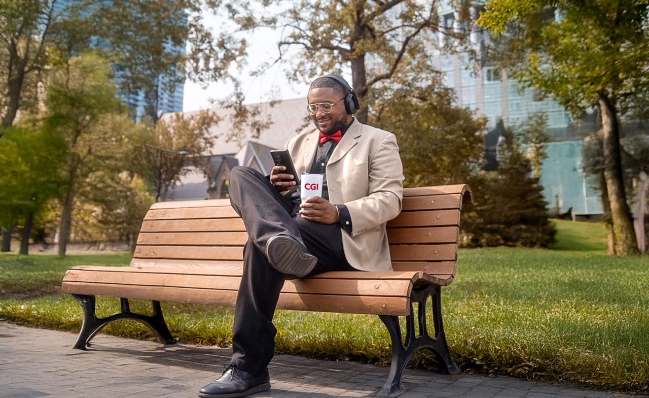 Man sitting on a bench reading outdoors Man sitting on a bench reading outdoors