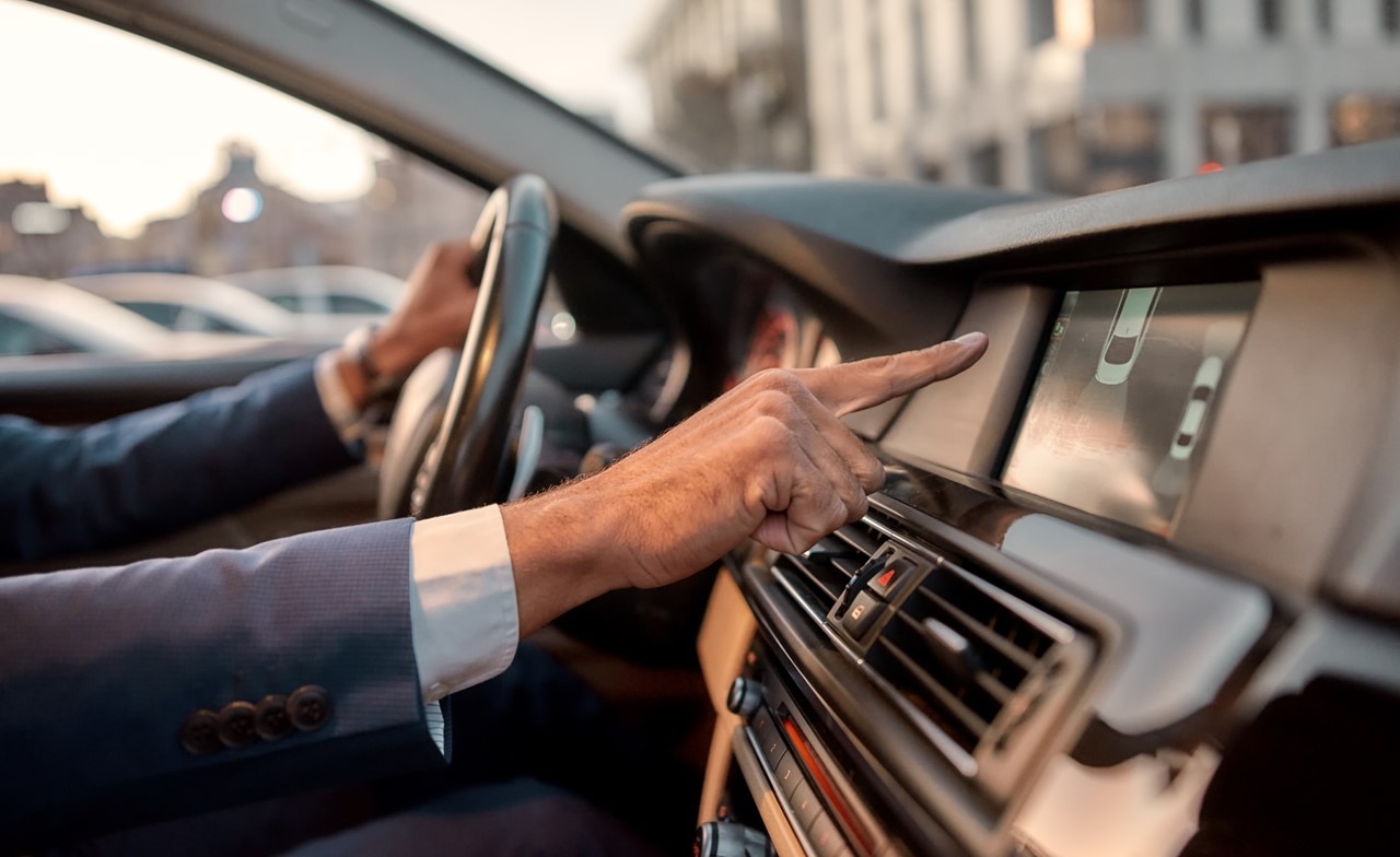 Man using parking assist system in a car Man using parking assist system in a car