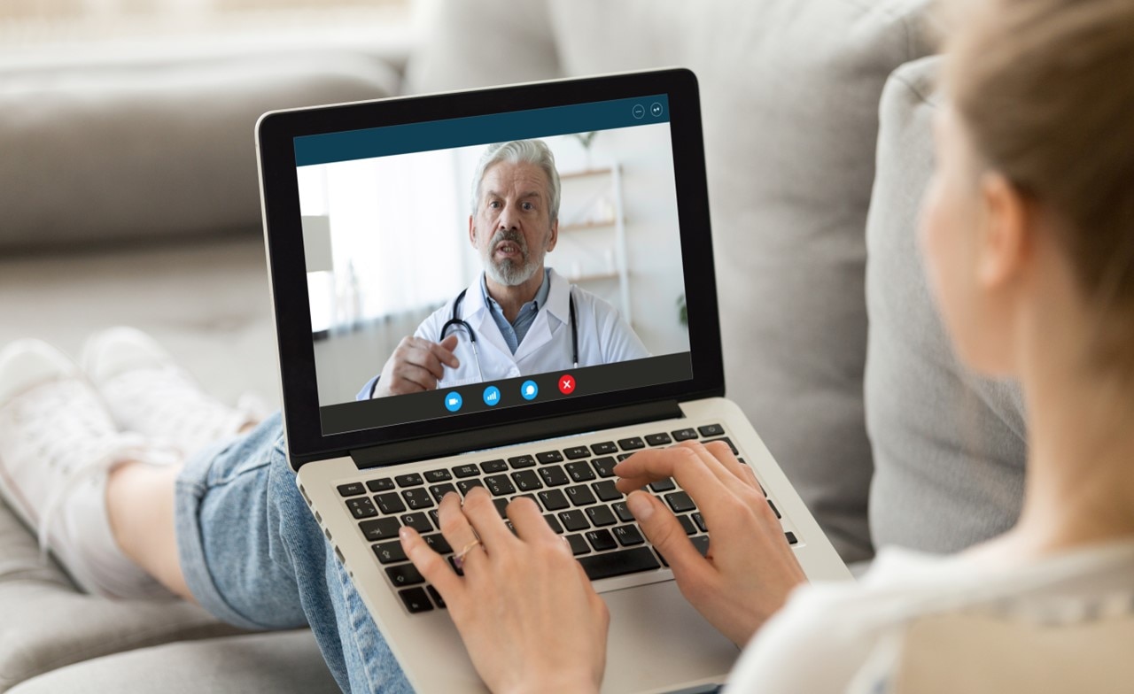 Patient talking to a doctor using a laptop during a telehealth appointment Patient talking to a doctor using a laptop during a telehealth appointment