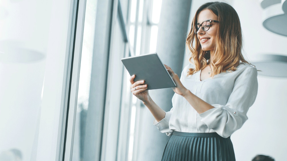 Lady in office looking at ipad