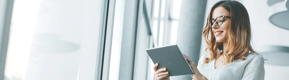 CGI Trade360 Receivables Lady in office looking at ipad