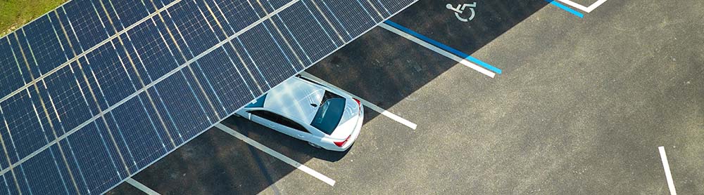 solar panel lot a car parked under a solar panel roof in a public lot