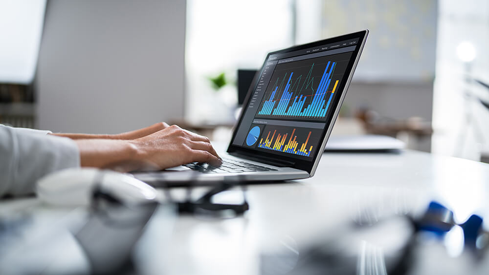 hands typing on keyboard with data on computer screen hands typing on keyboard with data on computer screen