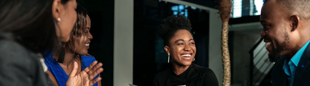 People in a meeting and laughing