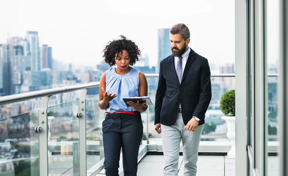Two consultants walking and talking Two consultants walking and talking