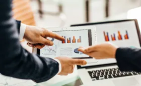 professionals reviewing data on a tablet device professionals reviewing data on a tablet device