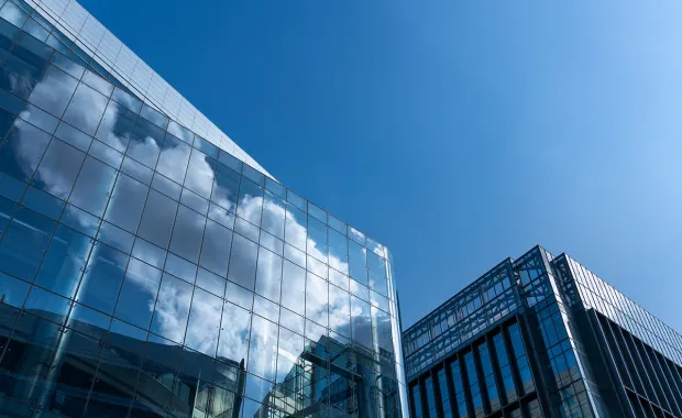 glass building with cloud reflected in the windows