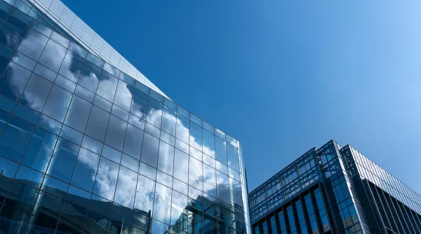 glass building with cloud reflected in the windows