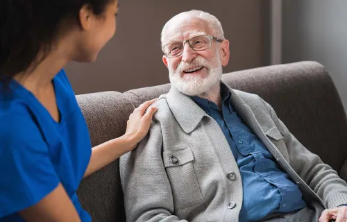 Healthcare professional talking to elderly patient