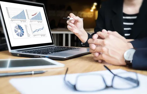 bank executive reviewing data charts on monitor