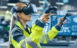 Industrial Engineer wearing virtual reality headset holding controllers