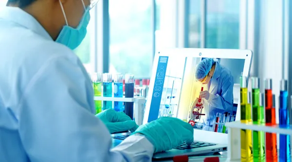 lab tech for poison control at laptop