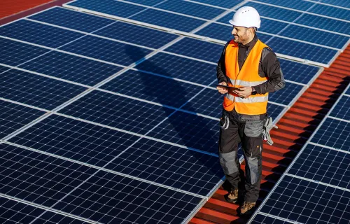 Man walking on solar panel roof