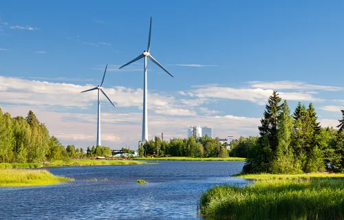 Windmill near lake and trees