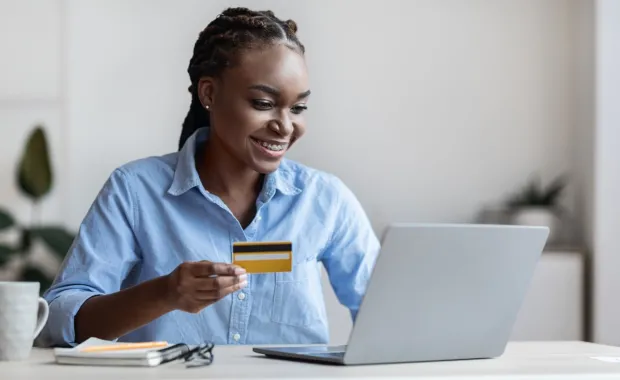 Person holding credit card and making online payment