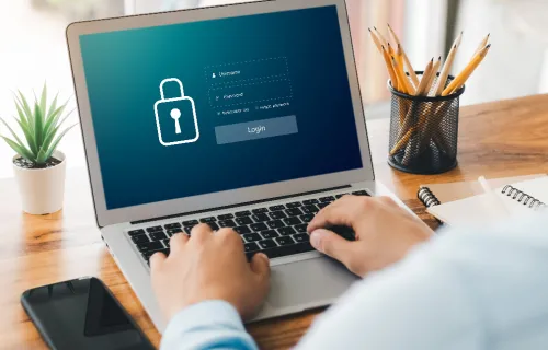 A person types on a laptop displaying a secure login screen, reflecting efforts to strengthen digital defenses and ransomware resiliency