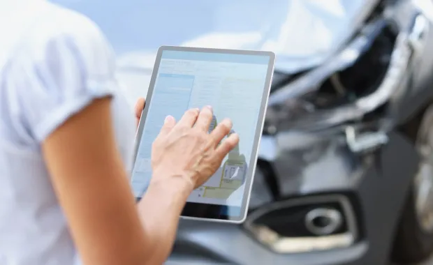person using tablet to assess vehicle damage