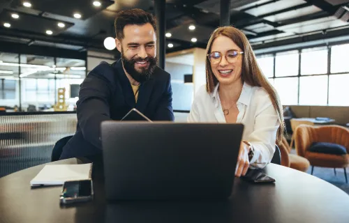 Two professionals looking at laptop