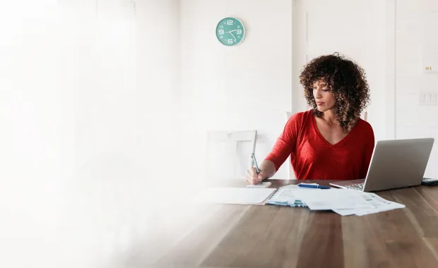 Woman looking at papers at table