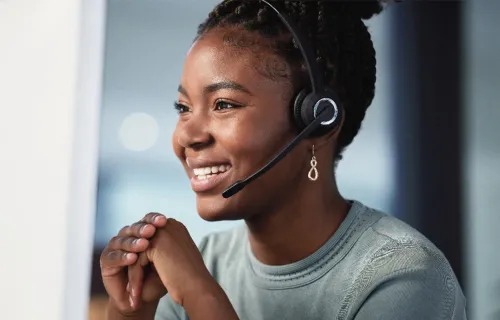 Lady smiling and wearing a headset