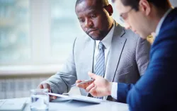 Two men consulting at the table