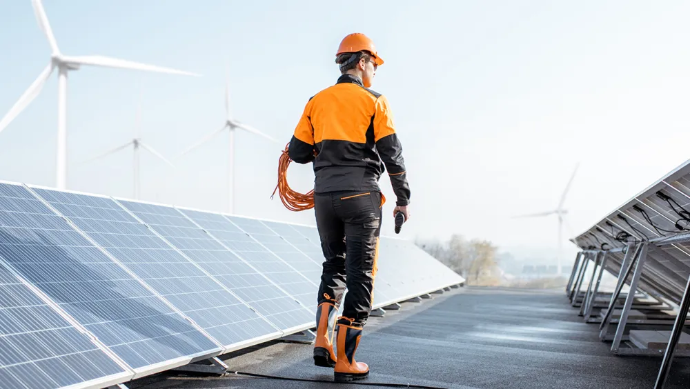 utilities worker check solar panels on a roof 